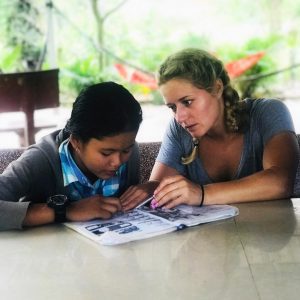 Sammy teaching a Cambodian girl english