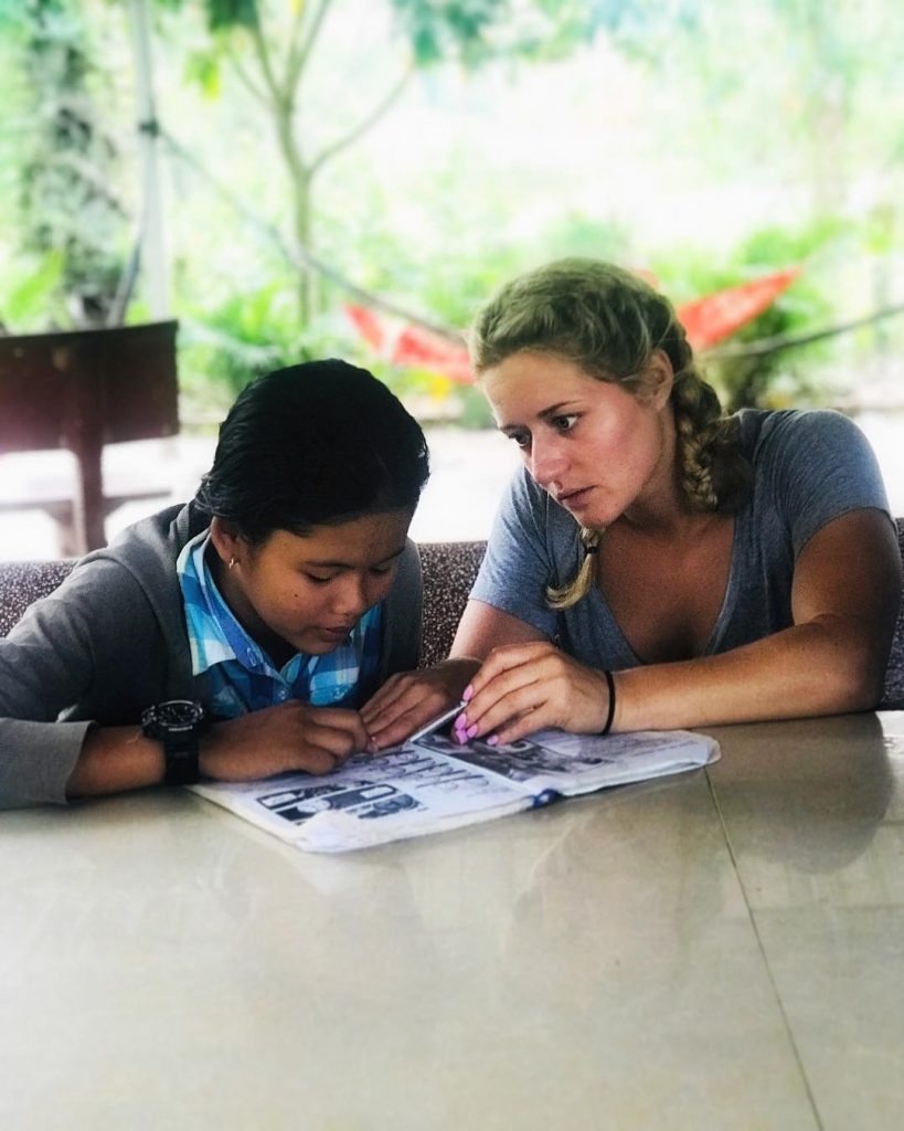 Sammy teaching a Cambodian girl english